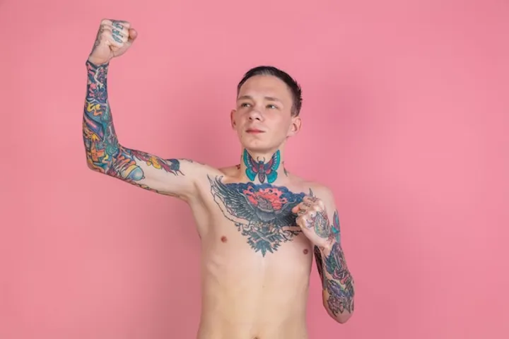 Tattoed man with the fist over his head